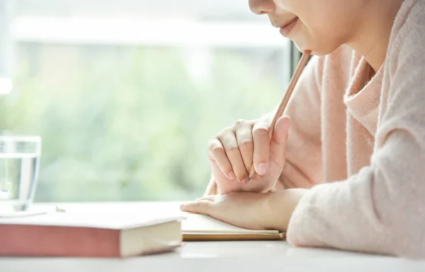 Happy Asian woman writing. — Stock Photo, Image