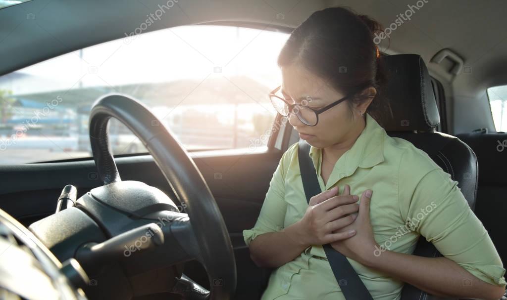 Asian business woman having chest pain from heart attack.