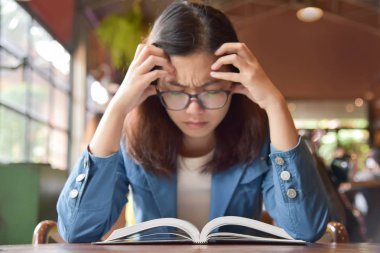 Kadın mavi tişört bir kitap okuma vurguladı.