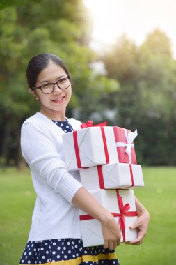 Asyalı kadın holding yığını hediye kutuları