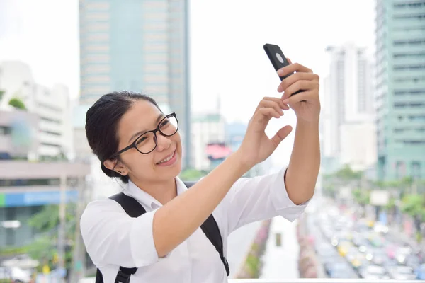 Женщина фотографируется со своим смартфоном . — стоковое фото
