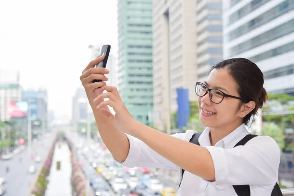 Женщина фотографируется со своим смартфоном . — стоковое фото