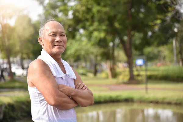 Asian Senior male posing with arms crossed.