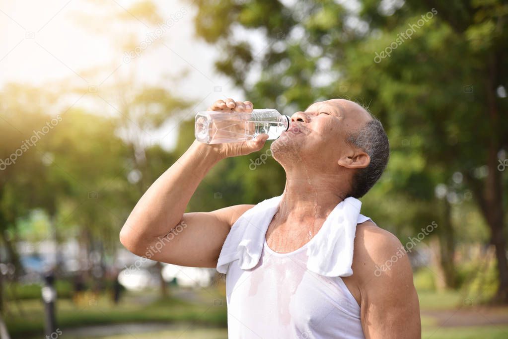 Asian senior male drinking water.