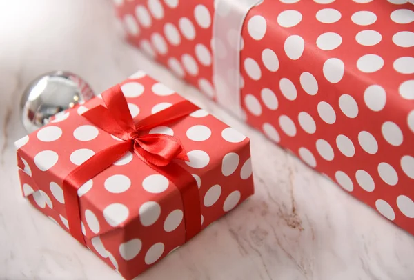 Red present box with white dot.