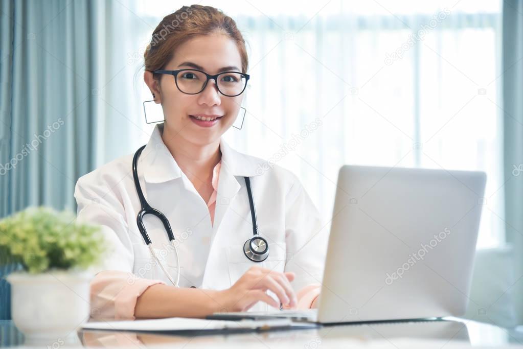 Female Doctor working with laptop.