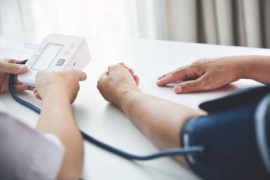 Kadın doktor tansiyon ölçme.