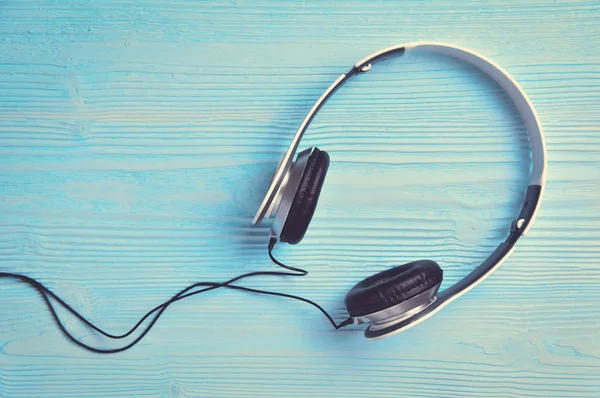 Headphone  on blue wooden background. — Stock Photo, Image