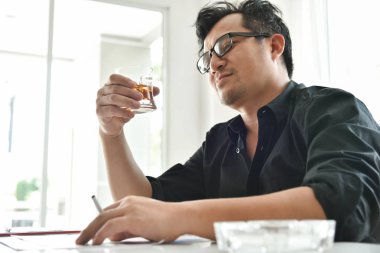 Alkol bağımlısı işadamı viski cam tutuyor.