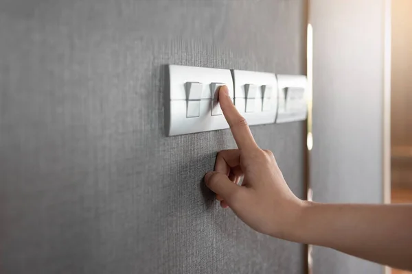 Turning on or off on grey light switch. — Stock Photo, Image