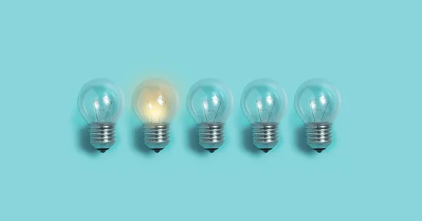 Light bulbs on blue background. — Stock Photo, Image