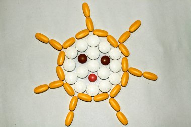 Tablets and capsules are lined in the form of the sun clipart
