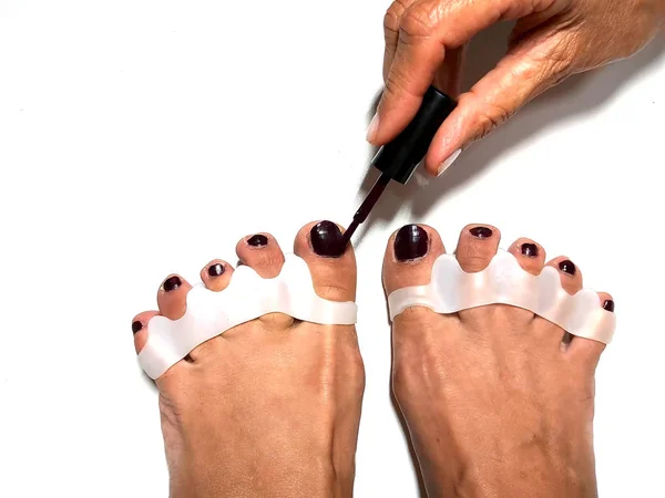 The master makes pedicures on toenails. Silicone finger device. — Stock Photo, Image