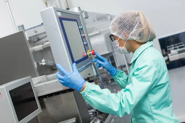 Factory worker configures control panel — Stock Photo, Image