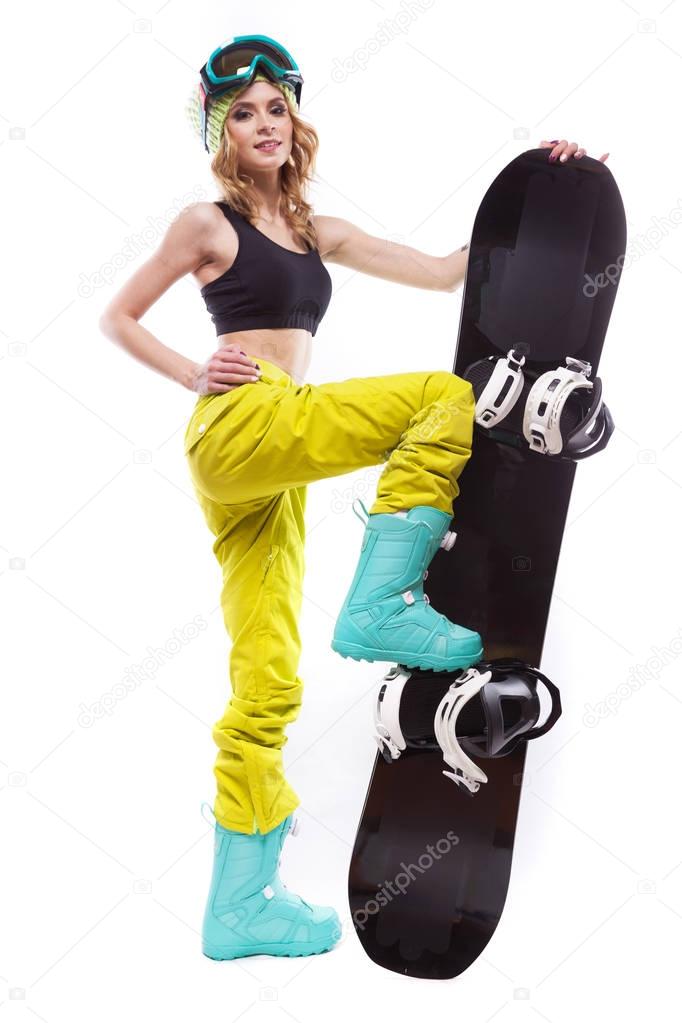 slim girl stands wiht snowboard one leg on
