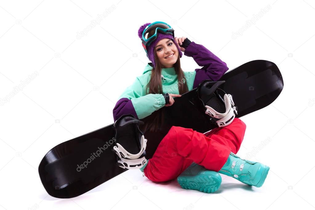 beauty girl sit on crossed legs with snowboard on knees