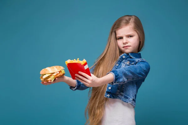 Ładna dziewczyna trzyma hamburger i frytki — Zdjęcie stockowe