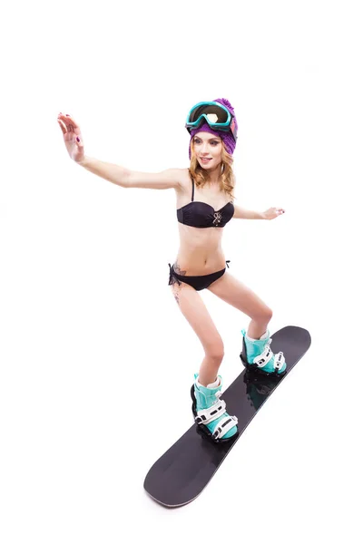 Jovem bonita mulher de biquíni no snowboard — Fotografia de Stock