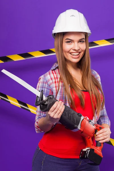 brunette woman in building helmet