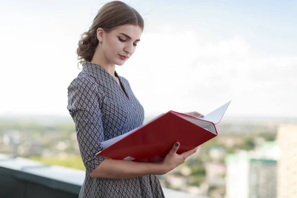 Business lady with folders on roof