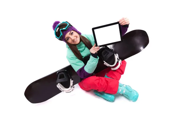 Ski woman with snowboard showing tablet — Stock Photo, Image