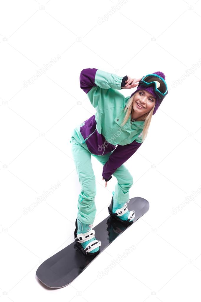 woman in ski suit rides snowboard