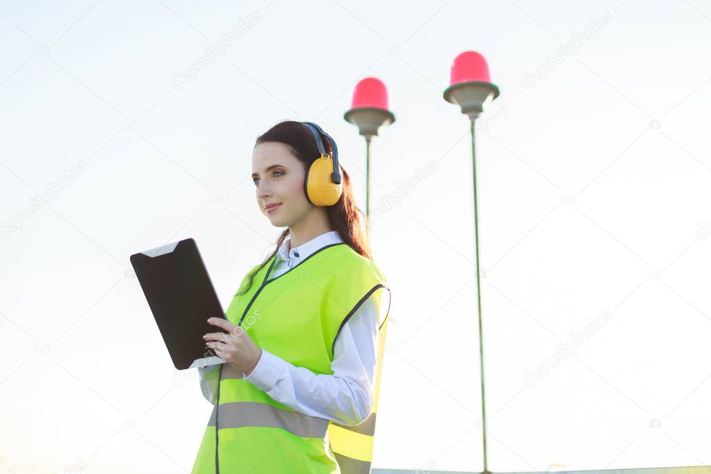 Girl with tablet on roof