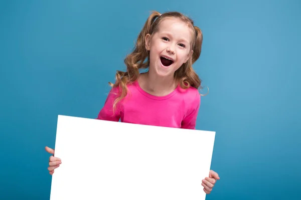 Little brunette girl with empty poster — Stock Photo, Image
