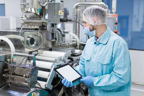 Scientist with tablet by metal tank — Stock Photo, Image