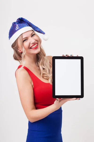 Woman in Christmas hat with tablet in hands