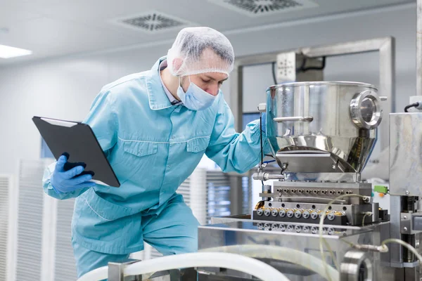 Scientist with tablet by metal tank — Stock Photo, Image