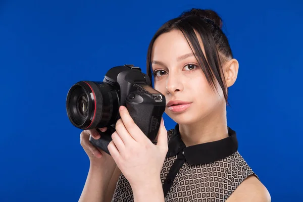 Smiling girl with camera in hands