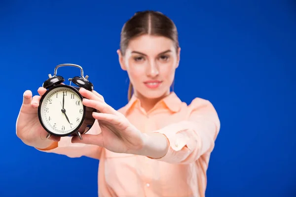 Girl with alarm clock Stock Picture