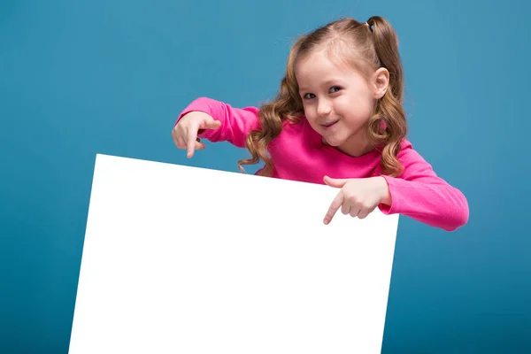 Little brunette girl with empty poster — Stock Photo, Image