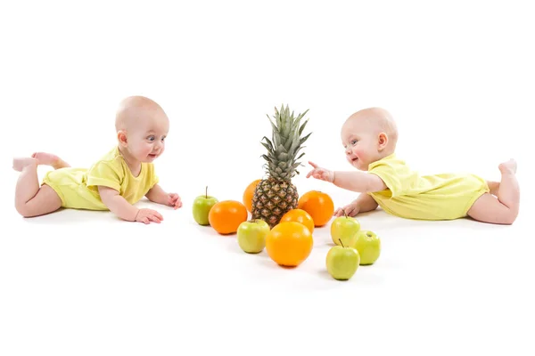 Cute babies with fruits — Stock Photo, Image