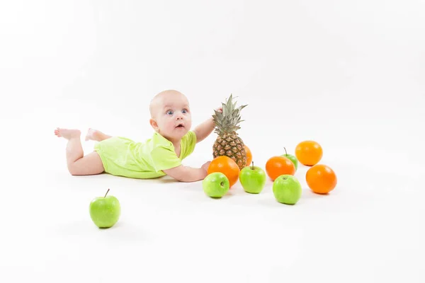 Cute baby boy with fruits — Stock Photo, Image