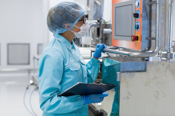 scientist standing near control panel