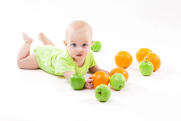 Cute boy with apples and oranges — Stock Photo, Image