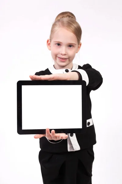 Schoolgirl in a suit with electronic tablet — Stock Photo, Image