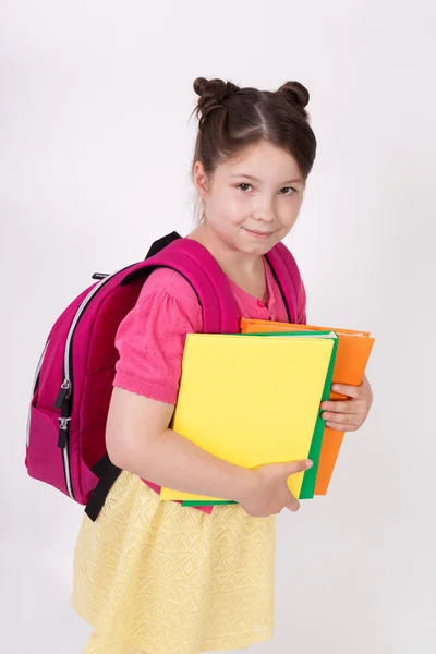 Colegiala sosteniendo libros — Foto de Stock