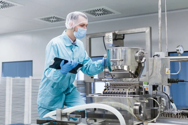 Scientist with tablet by metal tank — Stock Photo, Image