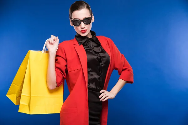 Girl in red jacket with paper bags — Stock Photo, Image