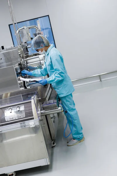 scientist standing near tank in factory