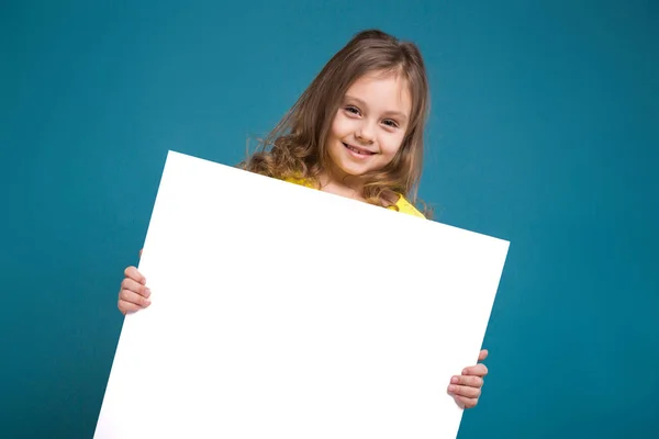 Cute brunette girl with empty poster — Stock Photo, Image