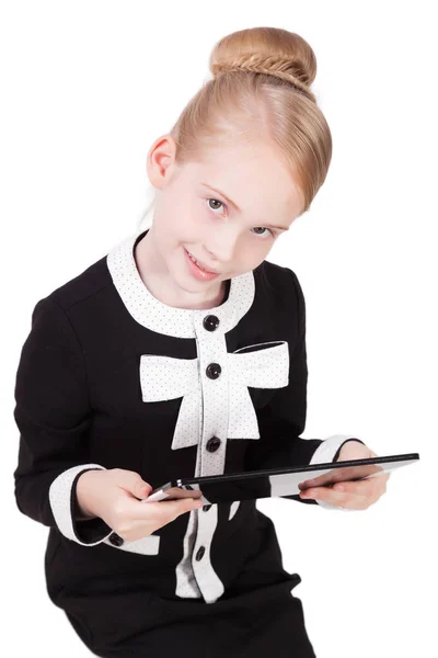 Colegiala en traje con tableta electrónica — Foto de Stock