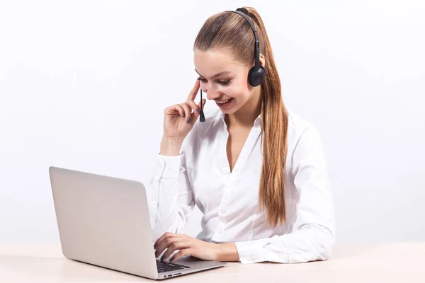 Girl with headset in front of a laptop — Stock Photo, Image