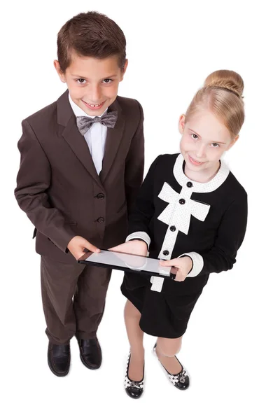 Niños de la escuela en trajes con tablet —  Fotos de Stock