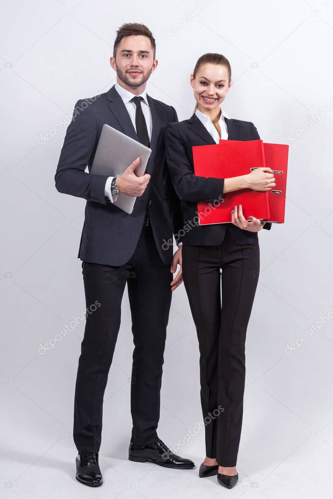 Young businesspeople with a laptop and office folders