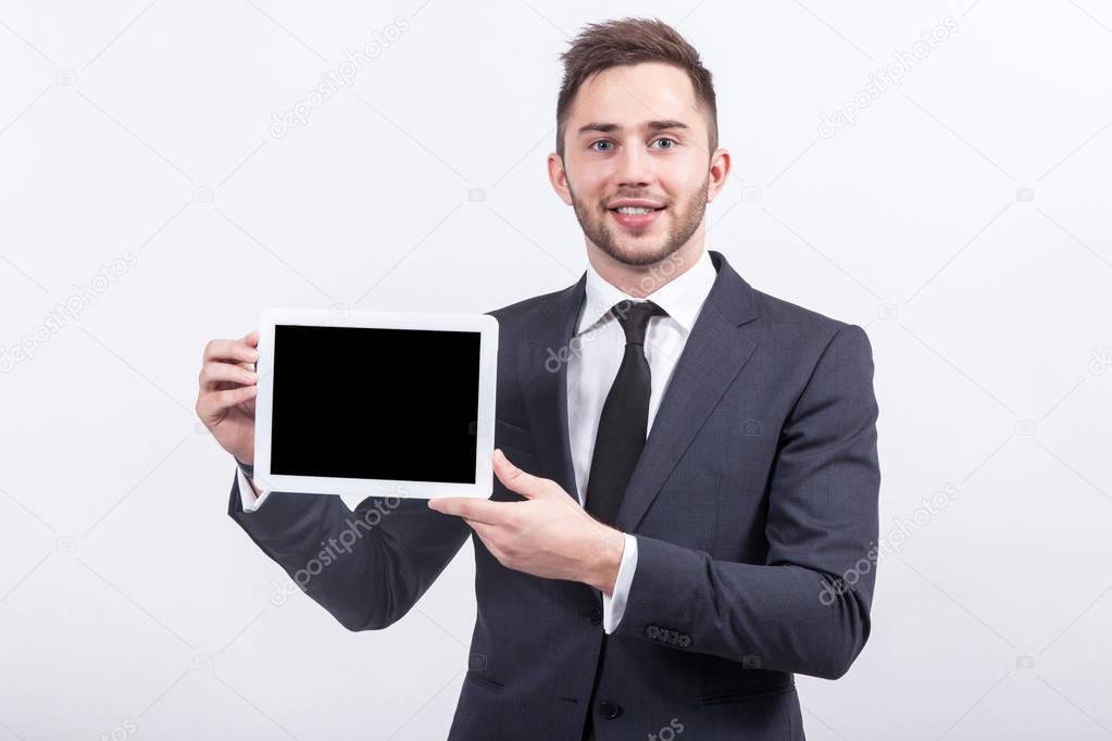 Young businessman with tablet in hands