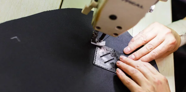 Woman sewing bag detail